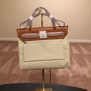 Elegant Tan and Cream Women's Bag, comes with wristlet, lock and key. Size 30